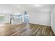 Open living room featuring wood floors, modern lighting, and an open kitchen concept at 395 Alcazar Ave, De Leon Springs, FL 32130