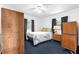 Cozy bedroom featuring blue carpet, white walls, a queen size bed, and two small windows at 4133 Cepeda St, Orlando, FL 32811