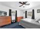 Bedroom featuring blue carpet, white walls, two small windows, and three dressers at 4133 Cepeda St, Orlando, FL 32811