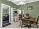 Dining room features a light green color scheme, a ceiling fan, and tiled floors at 4133 Cepeda St, Orlando, FL 32811