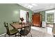 Dining room offers a traditional dining set, tile flooring, and a seamless transition into an enclosed porch at 4133 Cepeda St, Orlando, FL 32811