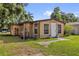Tan home with a white door and matching window trim, with a partially fenced in yard at 4133 Cepeda St, Orlando, FL 32811