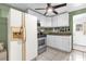 Kitchen featuring white cabinets, stainless steel appliances, and tile flooring at 4133 Cepeda St, Orlando, FL 32811