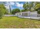 Spacious backyard with a well-maintained lawn, white fence, and a deck perfect for entertaining at 441 S Primrose Dr, Orlando, FL 32803