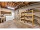 Large unfinished basement featuring a washer, dryer, shelving, and a utility sink at 441 S Primrose Dr, Orlando, FL 32803