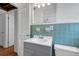 Charming bathroom featuring vintage blue tile backsplash, classic fixtures, and ample natural light at 441 S Primrose Dr, Orlando, FL 32803
