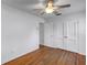 Simple bedroom with hardwood floors, a ceiling fan, and a double door closet at 441 S Primrose Dr, Orlando, FL 32803