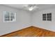 Bright bedroom with hardwood floors, ceiling fan, and two windows offering natural light at 441 S Primrose Dr, Orlando, FL 32803