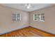 Inviting bedroom with hardwood floors, two windows, and neutral wall color at 441 S Primrose Dr, Orlando, FL 32803