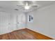 Comfortable bedroom with hardwood floors, a ceiling fan, double door closet, and a window at 441 S Primrose Dr, Orlando, FL 32803