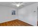Cozy bedroom featuring hardwood floors, a ceiling fan, and natural light from the window at 441 S Primrose Dr, Orlando, FL 32803