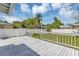 Backyard boasts a white wooden deck with railings and a white fence, ideal for relaxing at 441 S Primrose Dr, Orlando, FL 32803