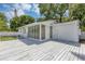 Inviting white wooden deck offers a perfect outdoor space with access to a sunroom and backyard at 441 S Primrose Dr, Orlando, FL 32803