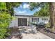 Home featuring a dark gray garage door, well-manicured landscaping, and inviting curb appeal at 441 S Primrose Dr, Orlando, FL 32803