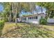 Beautifully landscaped front yard with mature trees providing ample shade to the home at 441 S Primrose Dr, Orlando, FL 32803