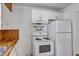 Functional kitchen with white appliances, wooden countertops, and classic cabinetry at 441 S Primrose Dr, Orlando, FL 32803