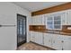 Traditional kitchen featuring white cabinets, wooden countertops, and a stainless steel sink at 441 S Primrose Dr, Orlando, FL 32803