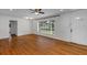 Bright living room with hardwood floors, a ceiling fan, and a large window at 441 S Primrose Dr, Orlando, FL 32803