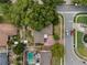 Aerial view of a home with patio, pool, lush landscaping, and driveway at 501 Benedict Ct, Casselberry, FL 32707