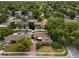 Aerial view of a home surrounded by trees and lush landscaping in a neighborhood at 501 Benedict Ct, Casselberry, FL 32707