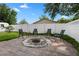 Backyard patio with fire pit and privacy fence at 501 Benedict Ct, Casselberry, FL 32707