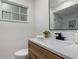 Modern bathroom features wood vanity, quartz countertop, and sleek fixtures at 501 Benedict Ct, Casselberry, FL 32707