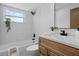Bright bathroom featuring a tub with white tile surround and modern fixtures at 501 Benedict Ct, Casselberry, FL 32707