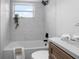 Bright bathroom featuring a tub with white tile surround and modern fixtures at 501 Benedict Ct, Casselberry, FL 32707
