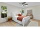 Bright bedroom features a ceiling fan, hardwood floors, and ample natural light from the windows at 501 Benedict Ct, Casselberry, FL 32707