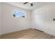 Empty bedroom features a ceiling fan, hardwood floors, a closet and ample natural light from the windows at 501 Benedict Ct, Casselberry, FL 32707