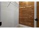 Walk-in closet with a wooden accent wall and metal shelving for optimal storage solutions at 501 Benedict Ct, Casselberry, FL 32707