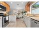 Bright kitchen boasts stainless steel appliances, granite countertops, and a dining area with modern chandelier at 501 Benedict Ct, Casselberry, FL 32707
