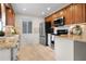 Well-equipped kitchen featuring stainless steel appliances, granite countertops, and wood cabinetry at 501 Benedict Ct, Casselberry, FL 32707