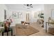 Bright and open living room flows into the dining area, featuring stylish decor and wood floors at 501 Benedict Ct, Casselberry, FL 32707