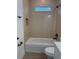 Bright bathroom showcasing a tiled shower/tub, black fixtures, and modern finishes at 524 Marion Oaks Blvd, Ocala, FL 34473