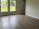 Bright, airy bedroom with wood-look flooring, two large windows, and neutral paint at 524 Marion Oaks Blvd, Ocala, FL 34473