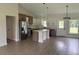 Stylish kitchen with white and wood cabinets, stainless appliances, island and modern pendant lighting at 524 Marion Oaks Blvd, Ocala, FL 34473