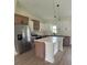 Spacious kitchen with stainless appliances, quartz countertops, a center island and stylish cabinetry at 524 Marion Oaks Blvd, Ocala, FL 34473