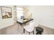 Stylish home office with sleek black and gold desk, white chairs, and statement artwork at 5832 Meditation Dr, Clermont, FL 34714