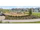 A modern community playground with benches, slide, and play structures surrounded by new homes, offering outdoor recreation at 5832 Meditation Dr, Clermont, FL 34714