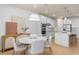 Eat-in kitchen features modern lighting, hardwood floors, kitchen island, and neutral color palette at 6005 Blue View Way, St Cloud, FL 34771