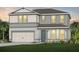 Charming two-story home with a well-maintained lawn, neutral tones, and attached two car garage at 6005 Blue View Way, St Cloud, FL 34771