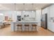 Modern kitchen with stainless steel appliances and an island with seating and pendant lighting at 6005 Blue View Way, St Cloud, FL 34771