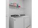 Bright laundry area features modern Whirlpool washer and dryer, plus convenient overhead storage shelf at 6005 Blue View Way, St Cloud, FL 34771
