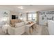 Comfortable living area with stylish decor, large sofa, and a modern media cabinet at 6005 Blue View Way, St Cloud, FL 34771