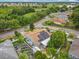 An aerial view showcases a house with solar panels and a green landscape in a residential neighborhood at 6902 Coral Cove Dr, Orlando, FL 32818