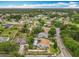 An aerial view highlights the neighborhood's layout, mature trees, and meticulously kept homes at 6902 Coral Cove Dr, Orlando, FL 32818