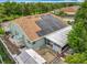 Aerial view of the home's roof with solar panels, the enclosed back porch, patio and landscaping at 6902 Coral Cove Dr, Orlando, FL 32818