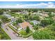 Wide aerial shot captures a single Gathering home surrounded by lush green trees and neighboring houses at 6902 Coral Cove Dr, Orlando, FL 32818