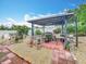 Outdoor entertaining area featuring a covered pergola with a built-in barbecue grill and seating at 6902 Coral Cove Dr, Orlando, FL 32818